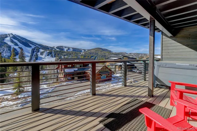 a view of a balcony with wooden floor and city view
