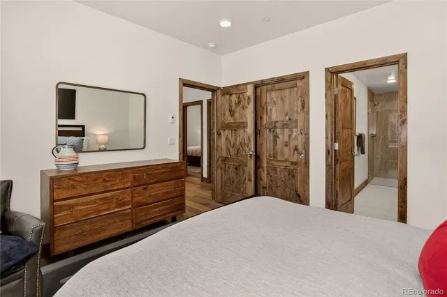 a bathroom with a double vanity sink a mirror and shower