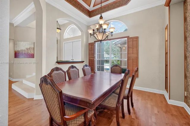 a kitchen with stainless steel appliances granite countertop a refrigerator a sink a stove and white cabinets