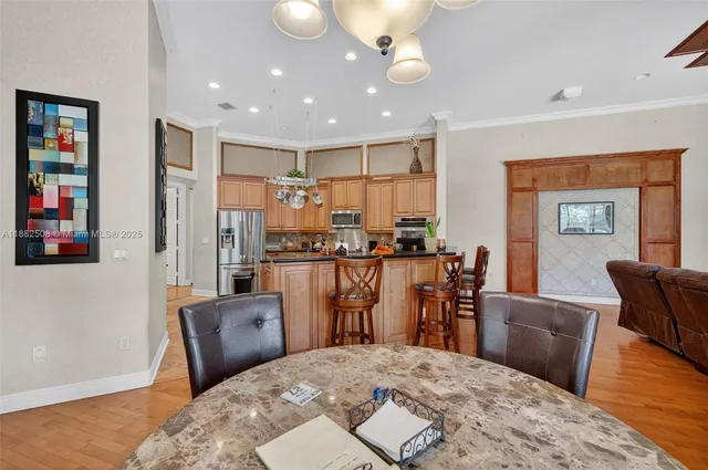 a kitchen with stainless steel appliances granite countertop a stove refrigerator and cabinets