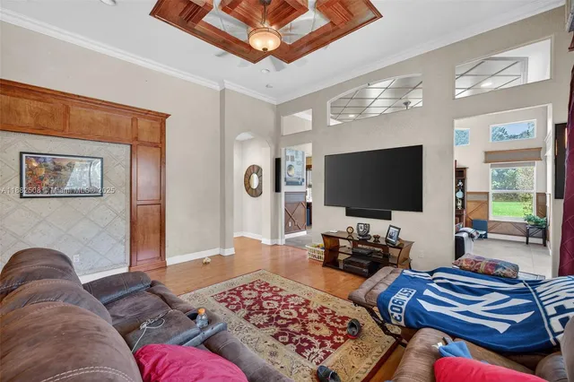a bedroom with furniture and a large window