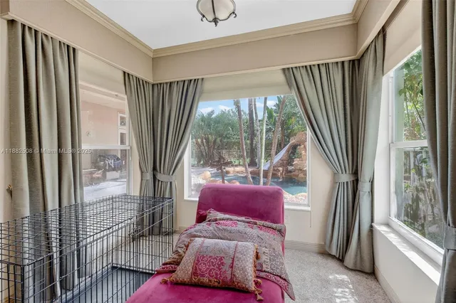 a backyard of a house with table and chairs under an umbrella