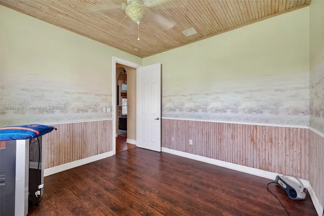an aerial view of a house with a yard and lake view