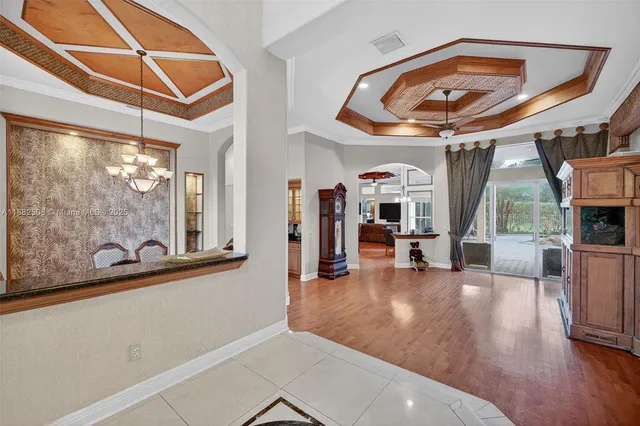 a view of a livingroom with furniture and a hallway