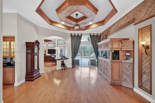 a dining room with furniture a chandelier and window