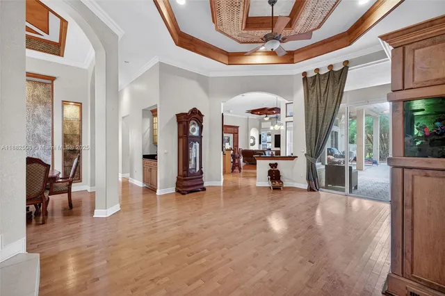 a view of a dining room with furniture a chandelier and wooden floor