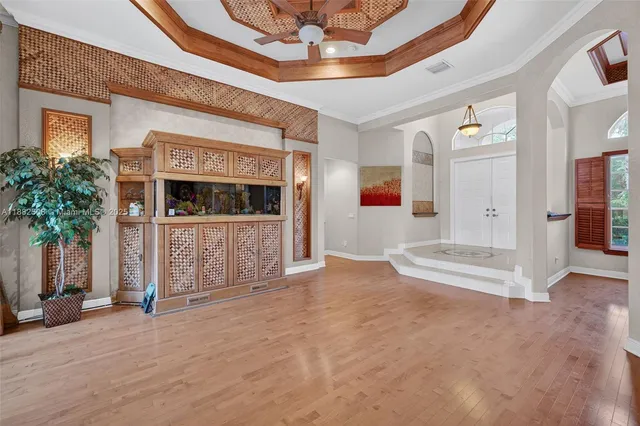 a view of a living room a dining room wooden floor and a window