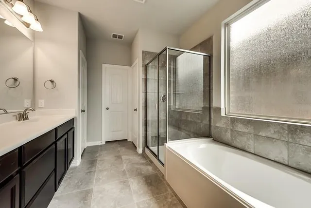 a bathroom with a bathtub and a sink