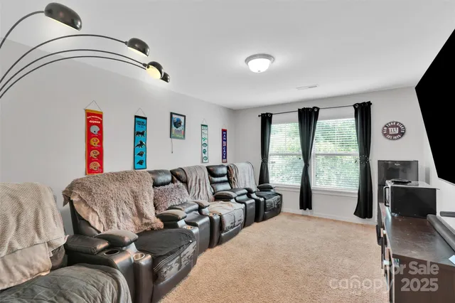 a living room with furniture and a floor to ceiling window