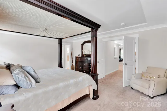 a bedroom with a bed and a large mirror