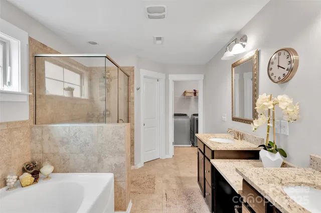 a bath room with a table chairs and a chandelier