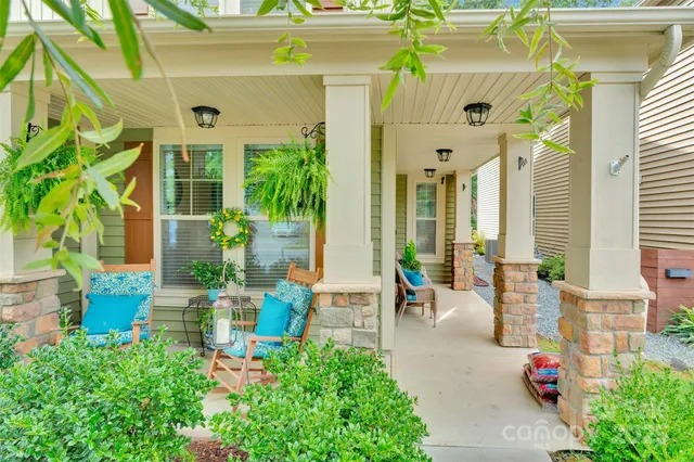 a front view of a house with outdoor seating and plants