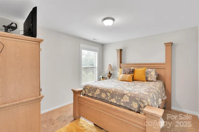 a bedroom with a bed and a refrigerator