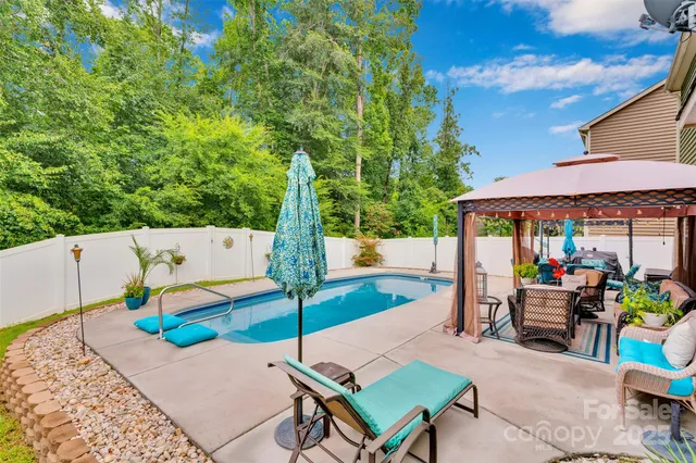 a view of a patio with a table and chairs under an umbrella