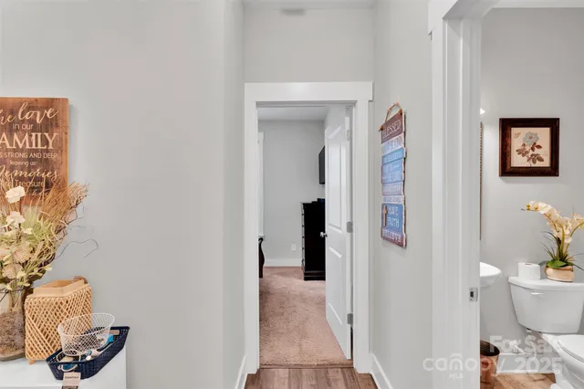 a bathroom with a toilet and a shower curtain