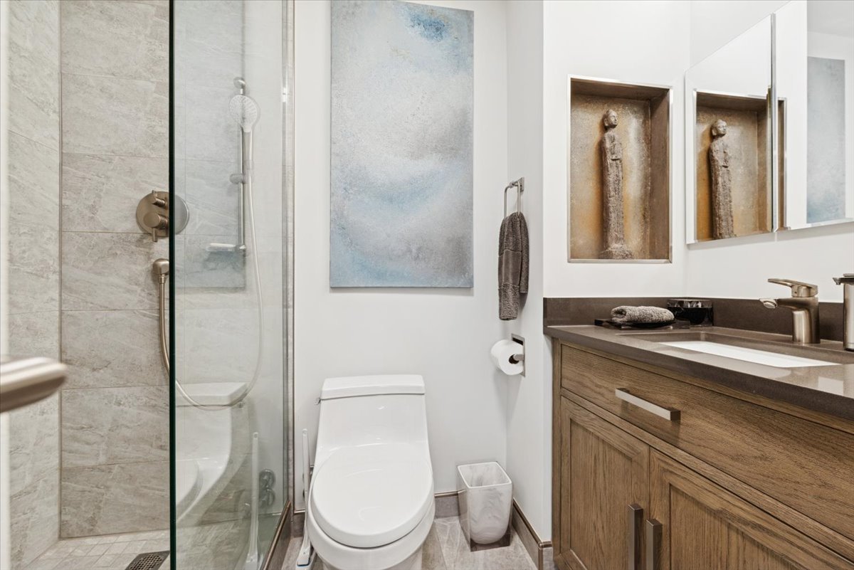 5415 North Sheridan Road, Unit 4805 Chicago, IL 60640 - Photo 14 of 30 a bathroom with a granite countertop toilet sink and mirror