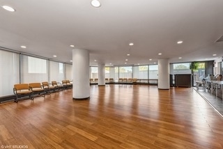 5415 North Sheridan Road, Unit 4805 Chicago, IL 60640 - Photo 20 of 30 a view of a room with kitchen island lot of furniture and wooden floor
