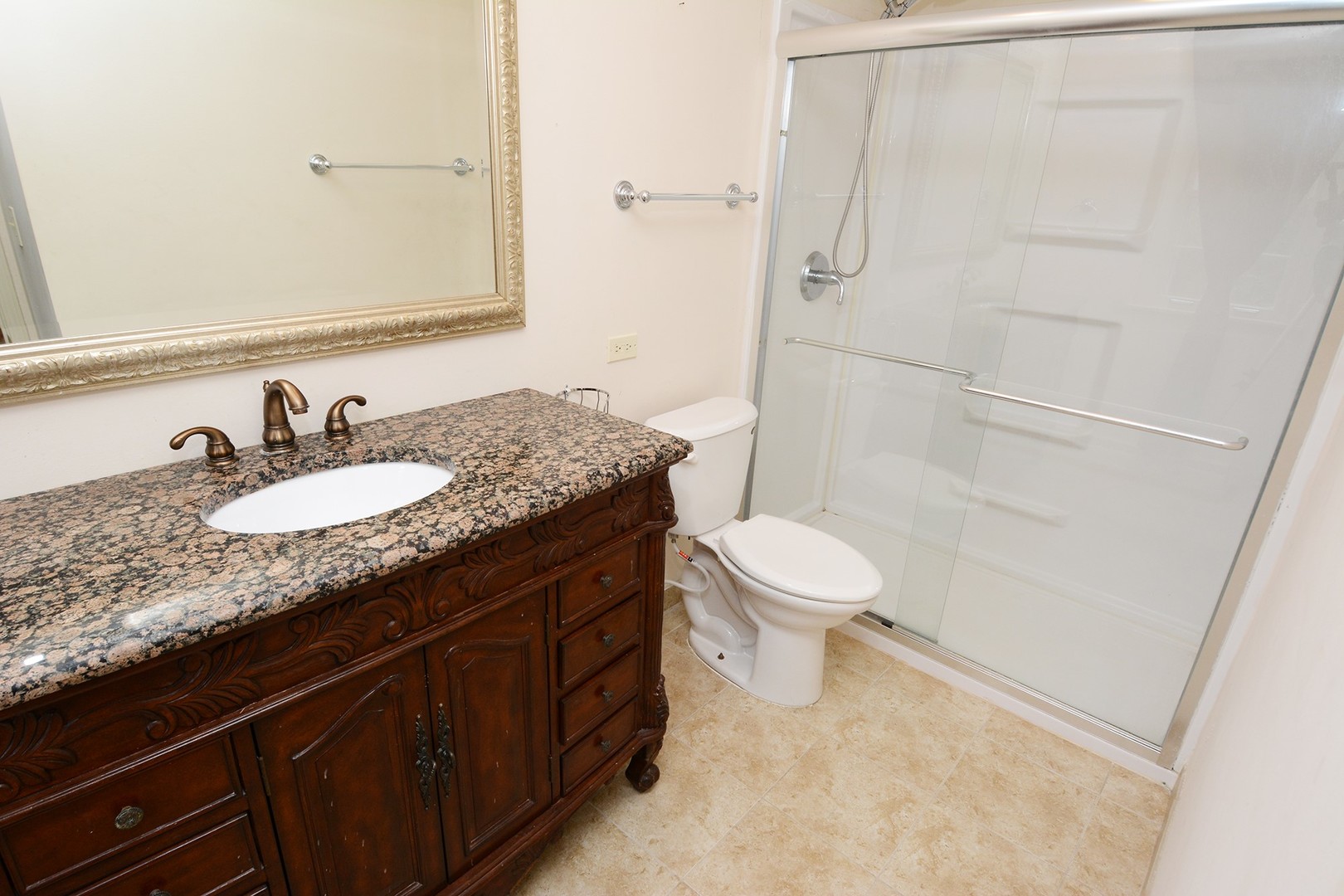 455 Lombard Road Itasca, IL 60143 - Photo 23 of 35 a bathroom with a granite countertop sink toilet and shower