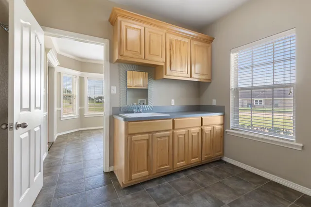 a view of a kitchen with granite countertop cabinets