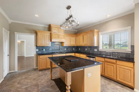 a kitchen that has a sink and a stove in it