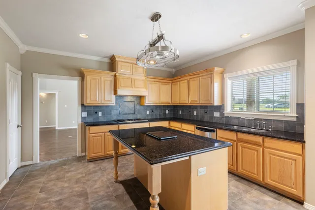 a kitchen that has a sink and a stove in it