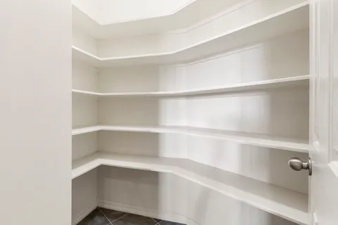 a view of walk in closet with empty racks