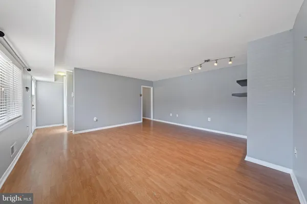 a view of an empty room with wooden floor