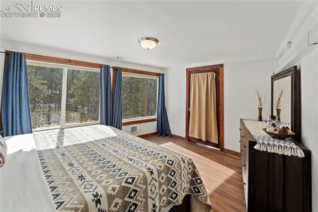 a bedroom with a bed and a large window