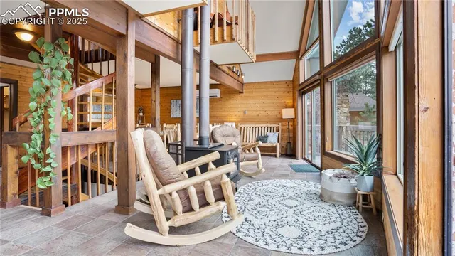 a living room with large windows and a rug