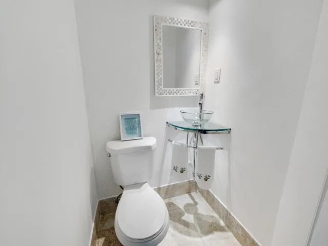 a white toilet sitting next to a bathroom sink