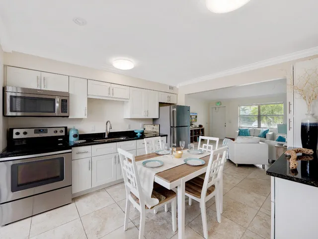 a kitchen with a dining table and chairs