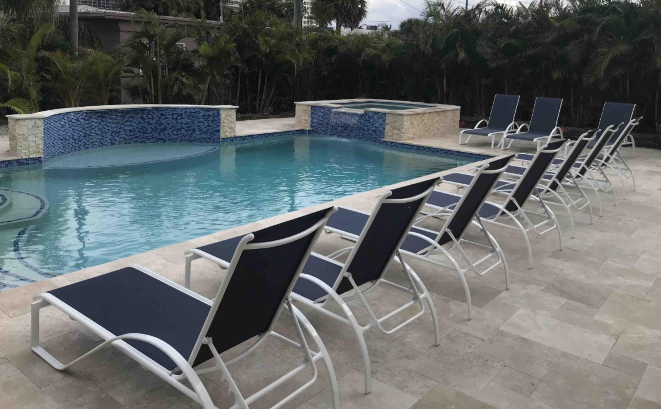 1236 Beach Road, Unit 4 Singer Island, FL 33404 - Photo 25 of 26 a view of a chairs and table on the terrace