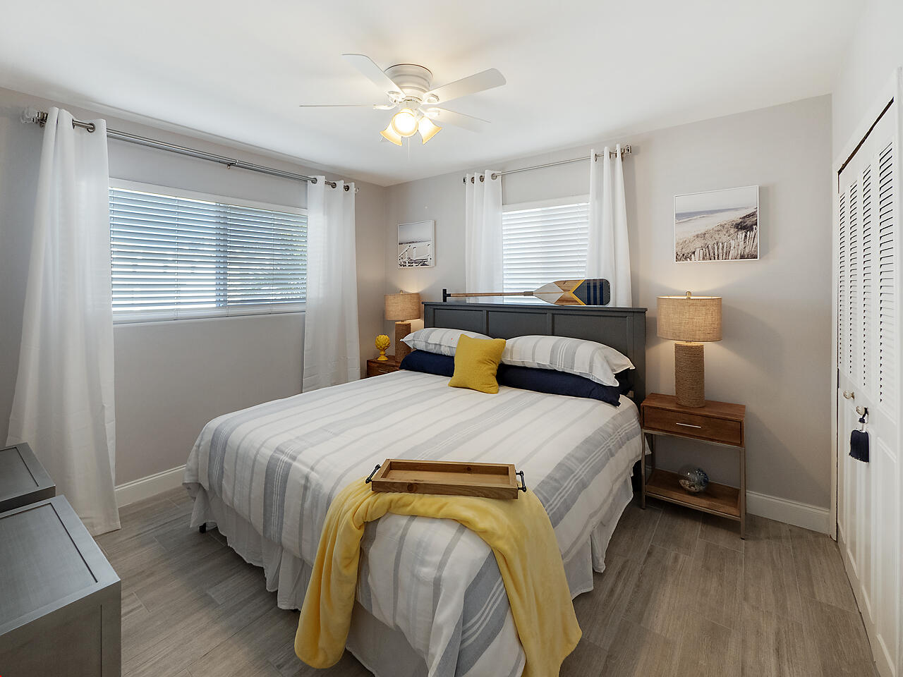 1236 Beach Road, Unit 4 Singer Island, FL 33404 - Photo 3 of 26 a bedroom with a bed and a chandelier