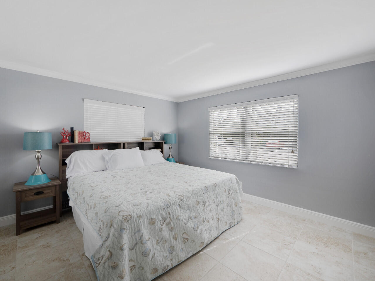 1236 Beach Road, Unit 4 Singer Island, FL 33404 - Photo 4 of 26 a bed sitting in a bedroom next to a window