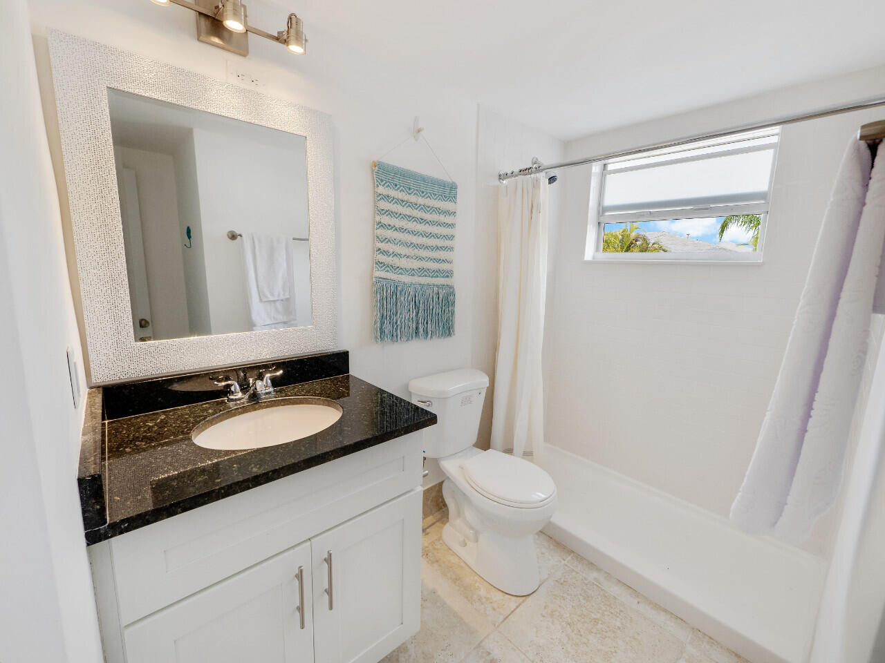 1236 Beach Road, Unit 4 Singer Island, FL 33404 - Photo 8 of 26 a bathroom with a granite countertop sink toilet and shower