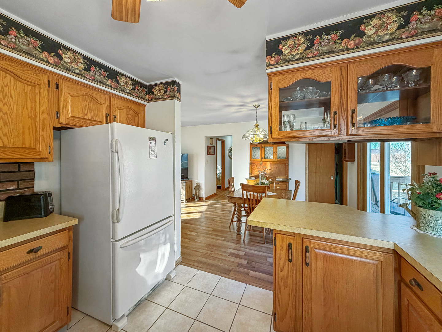6057 North Lake Road Lena, IL 61048 - Photo 6 of 22 a kitchen with a refrigerator a stove and a sink
