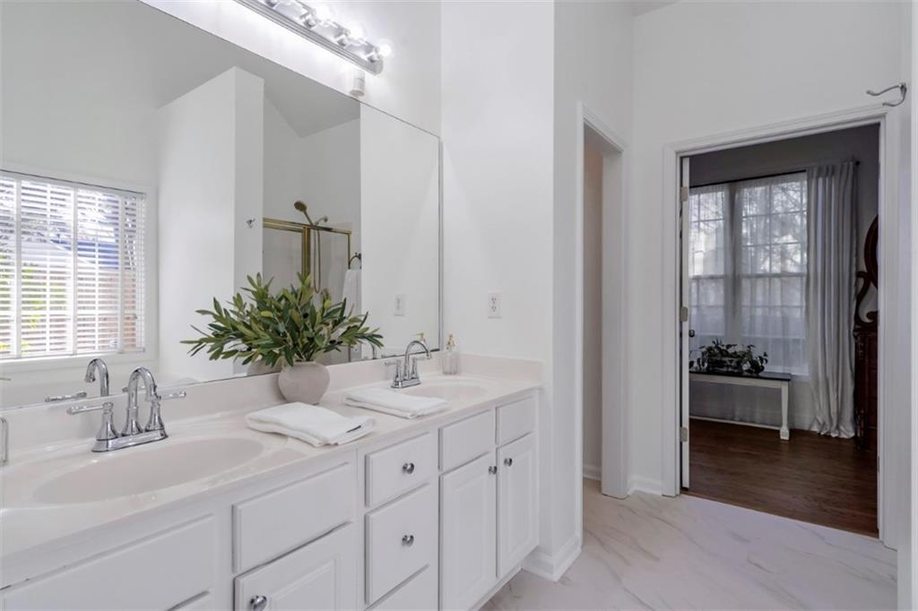 1075 Julius Drive Suwanee, GA 30024 - Photo 12 of 21 a bathroom with a tub a sink and mirror