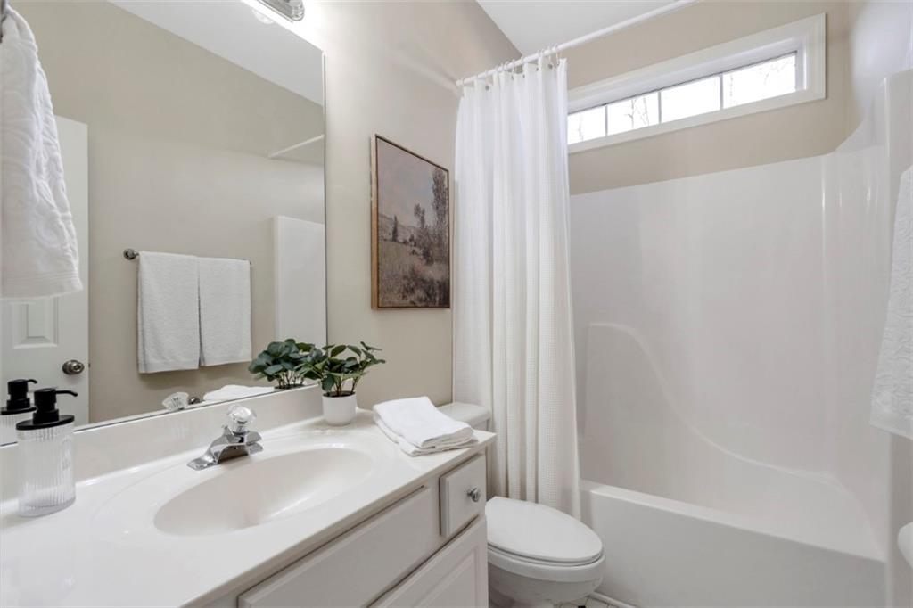 1075 Julius Drive Suwanee, GA 30024 - Photo 16 of 21 a bathroom with a sink toilet and shower
