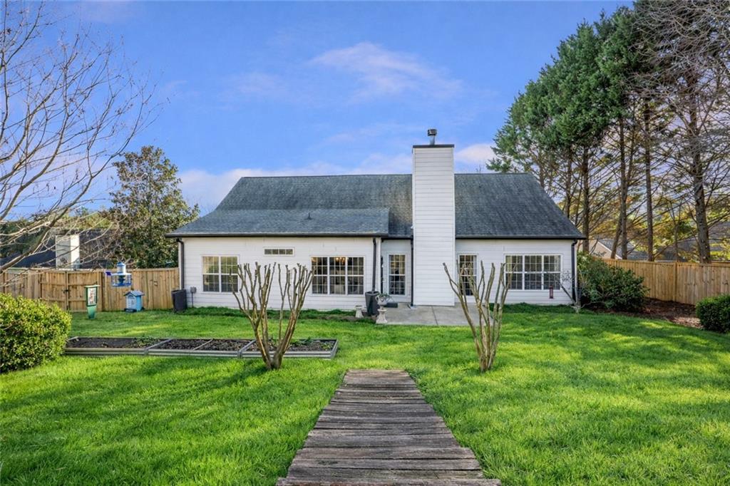 1075 Julius Drive Suwanee, GA 30024 - Photo 17 of 21 a front view of house with yard and green space