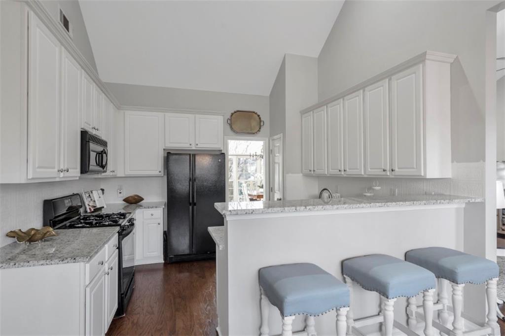 1075 Julius Drive Suwanee, GA 30024 - Photo 8 of 21 a kitchen with stainless steel appliances granite countertop a sink stove and refrigerator