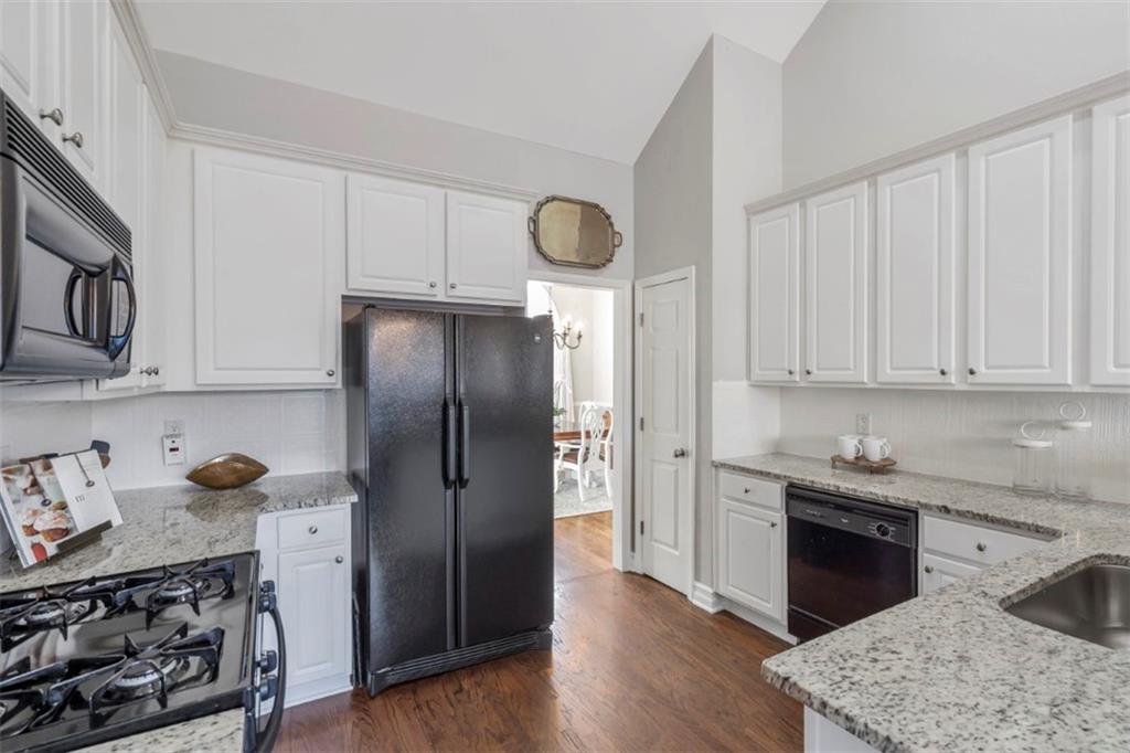 1075 Julius Drive Suwanee, GA 30024 - Photo 9 of 21 a kitchen with stainless steel appliances granite countertop a refrigerator sink and stove