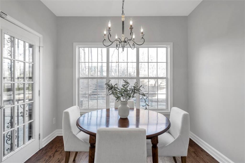 1075 Julius Drive Suwanee, GA 30024 - Photo 10 of 21 a dining room with chandelier and wooden floor