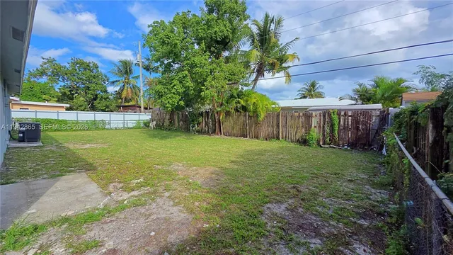 a view of a garden with a house in the background