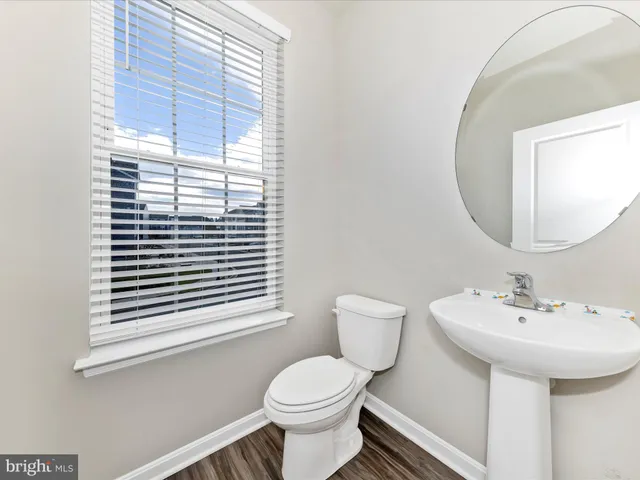 a bathroom with a sink a mirror and a toilet