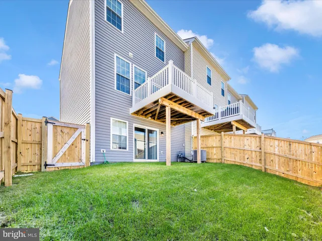 a view of a house with a big yard plants and large trees