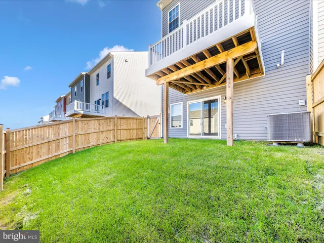 a view of backyard with deck and barbeque oven