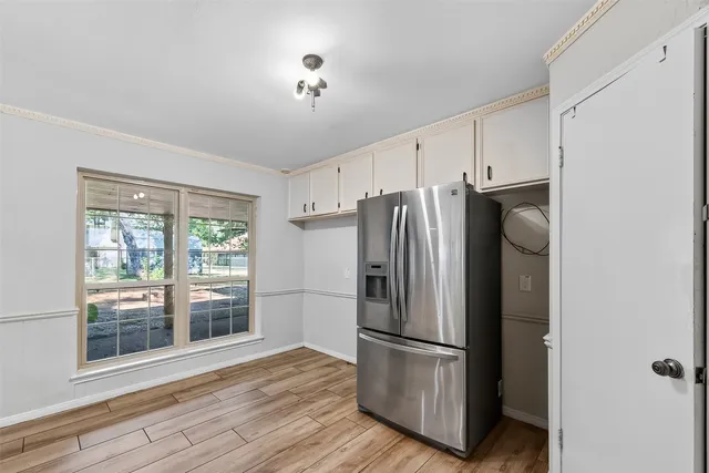 a metallic refrigerator freezer sitting in a kitchen