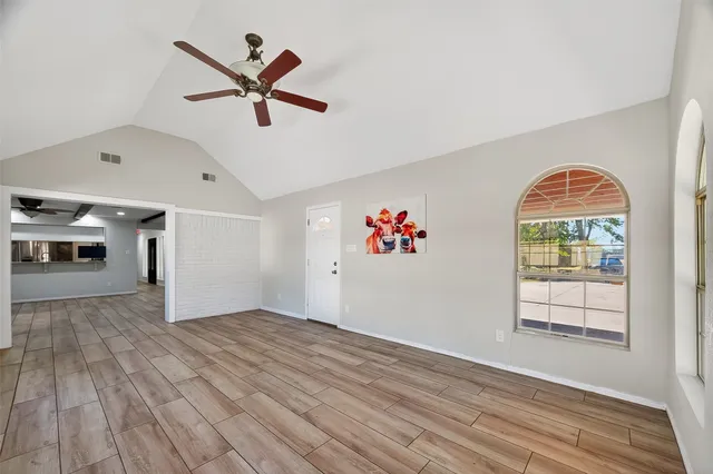 wooden floor in an empty room with a window
