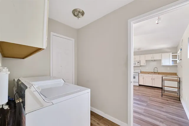 a view of washer and dryer with wooden floor