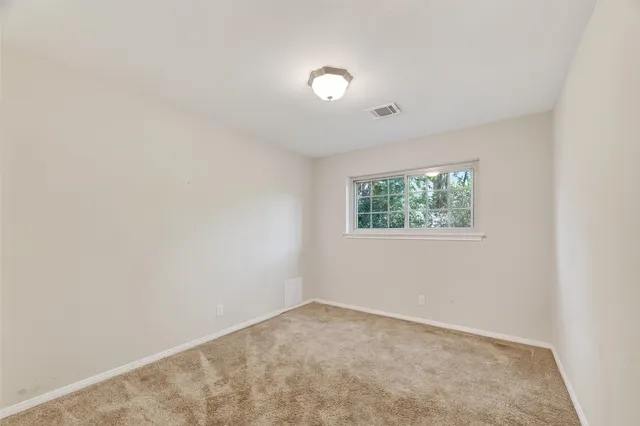 an empty room with closet area